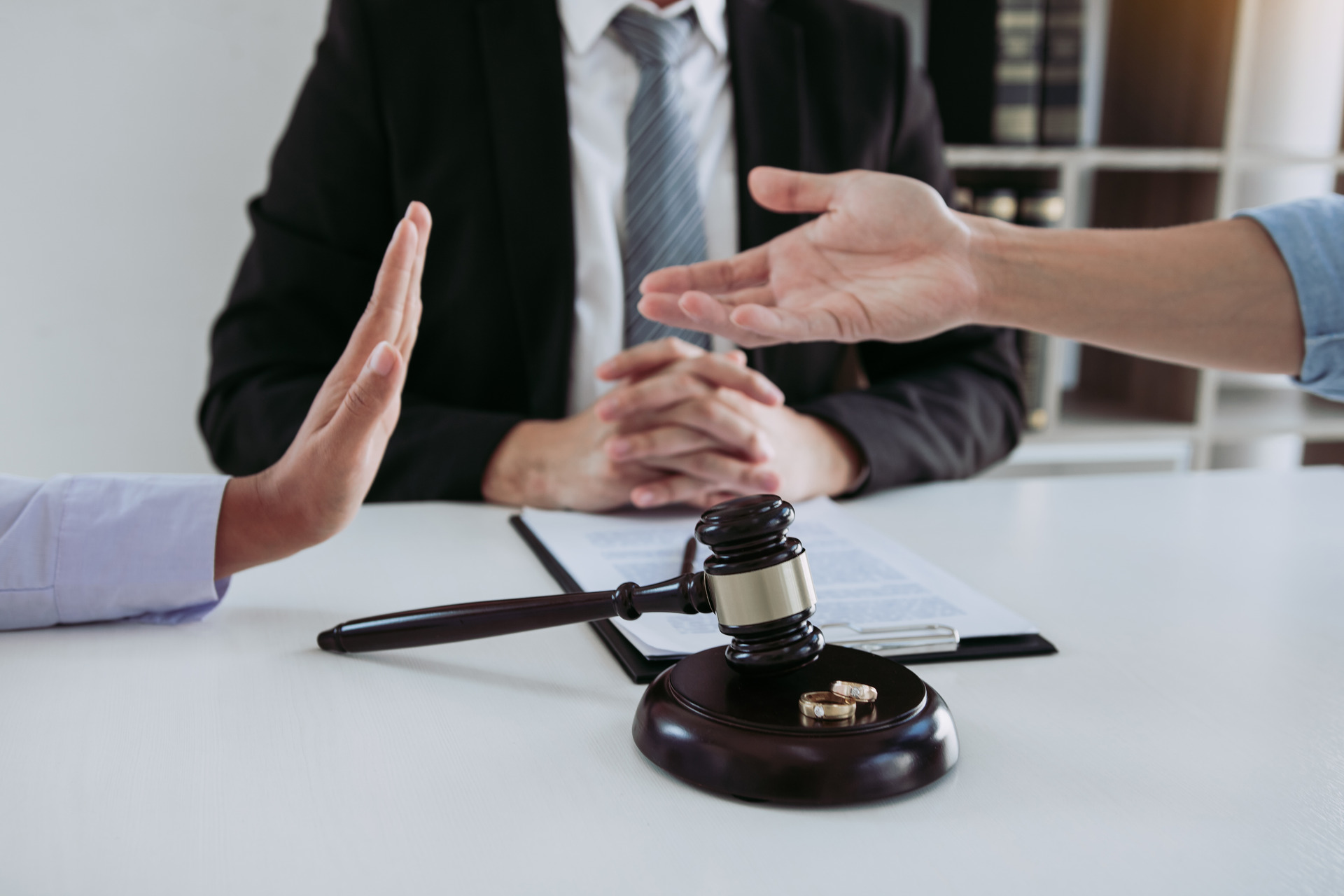 Divorce-settlement-meeting-with-a-lawyer-featuring-a-gavel-and-wedding-rings-symbolizing-legal-separation.-Huntington-Beach-Divorce-Lawyer-providing-expert-legal-assistance